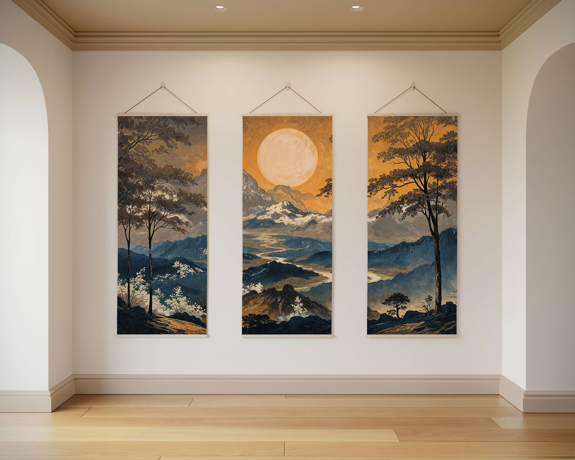 Three landscape paintings hanging on a wall in a room with wooden flooring.