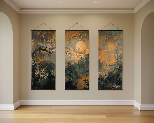 Three vertical artworks hanging on a wall in a room with wooden flooring.