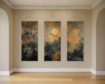 Three vertical artworks hanging on a wall in a room with wooden flooring.
