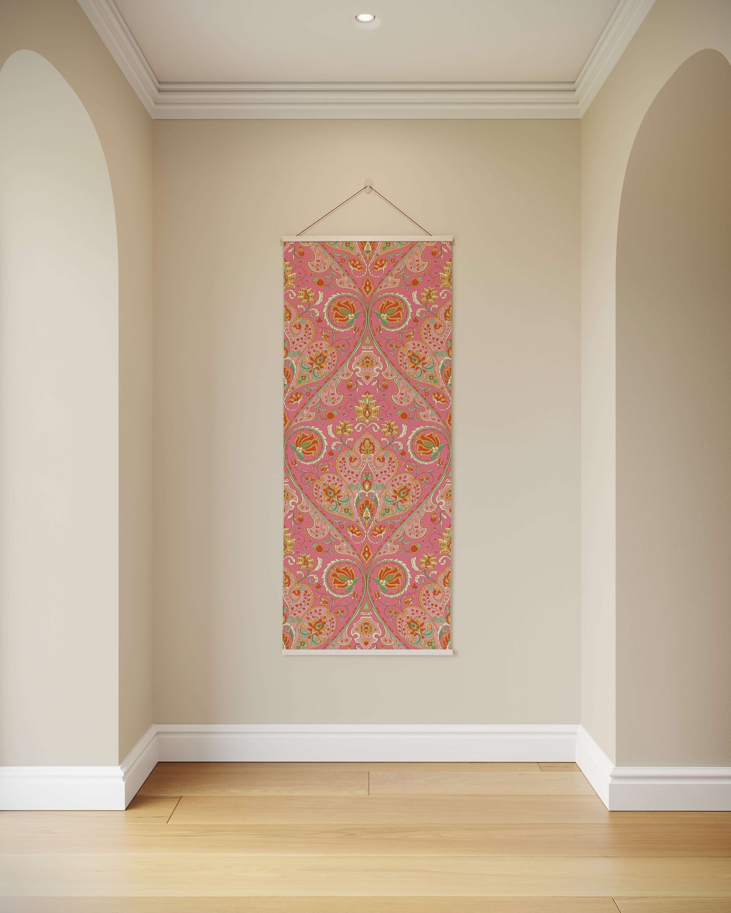 Decorative wall hanging with pink and multicolour pattern on a beige wall.