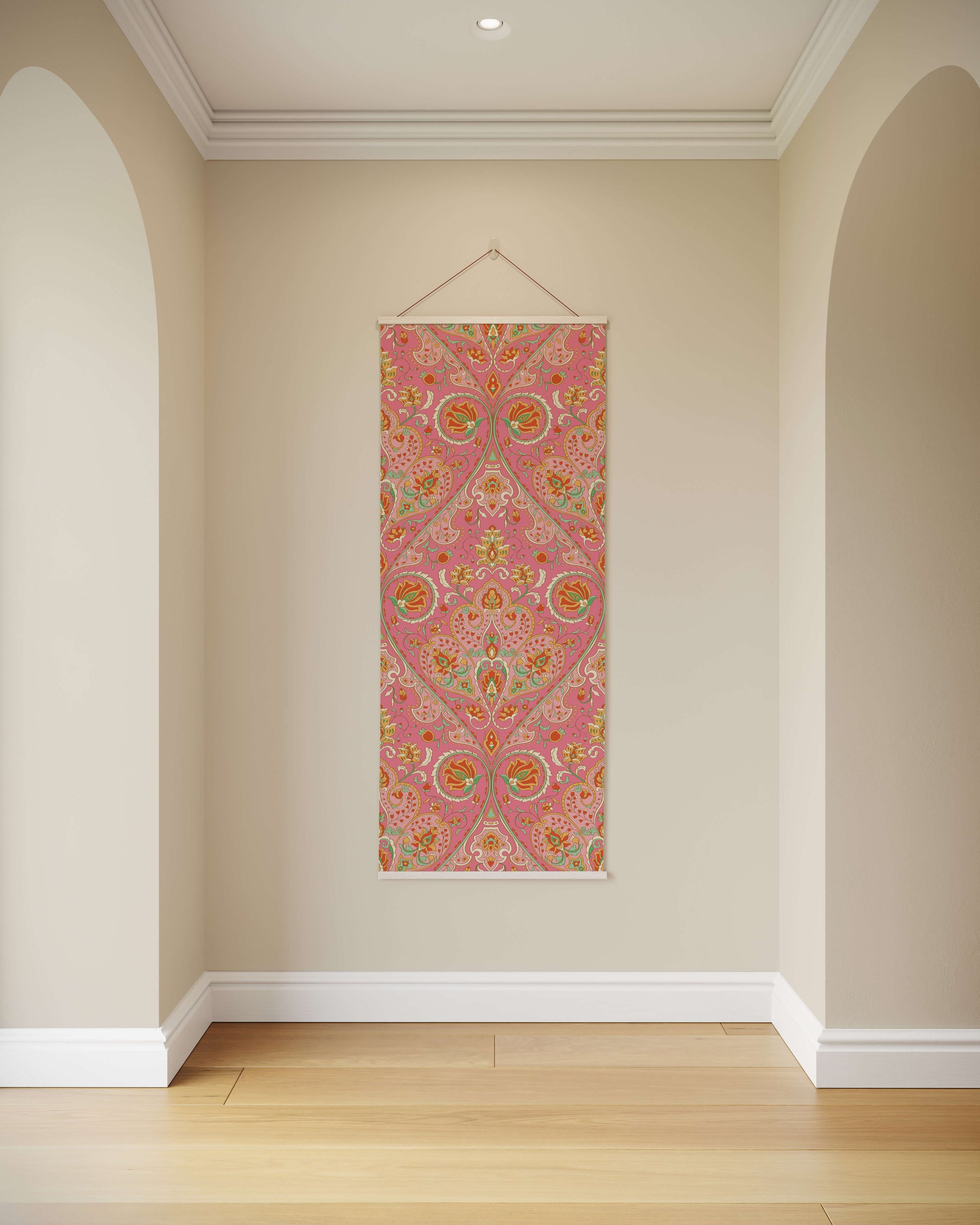 Decorative wall hanging with pink and multicolour pattern on a beige wall.
