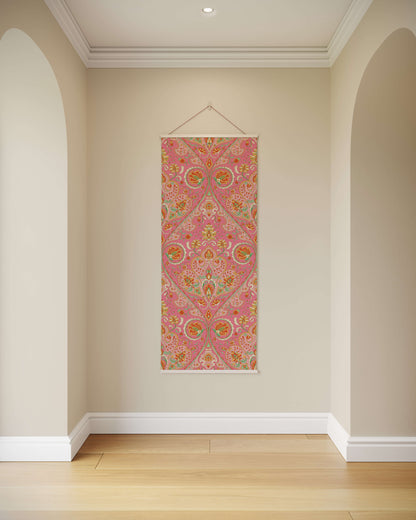 Decorative wall hanging with pink and multicolour pattern on a beige wall.