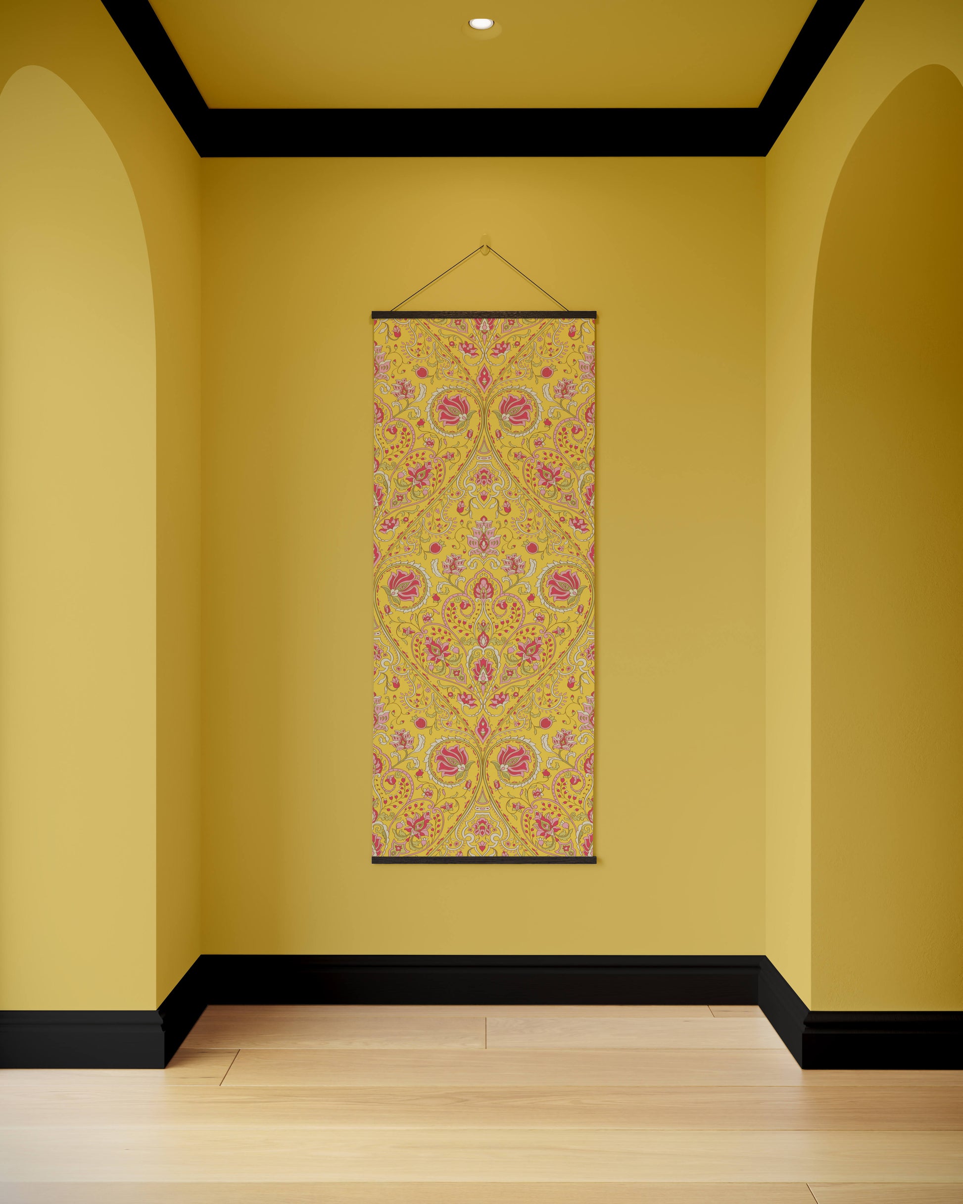 Decorative floral tapestry hanging on a yellow wall with arches.