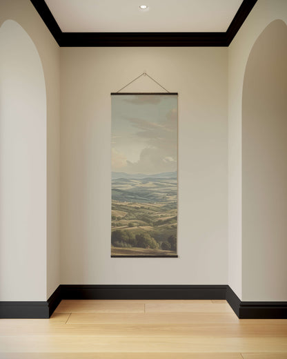 Wall art of a landscape hanging in a room with arched doorways and a wooden floor.