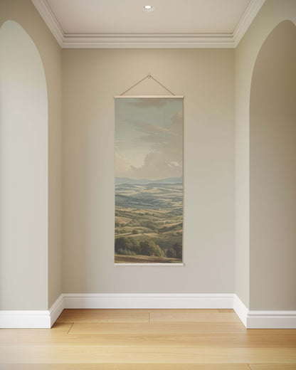 Wall painting of a landscape hanging on a beige wall with wooden floor.