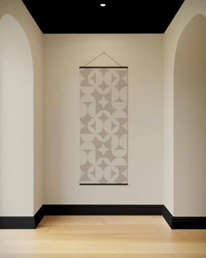 Decorative wall hanging with geometric pattern in a minimalistic room.