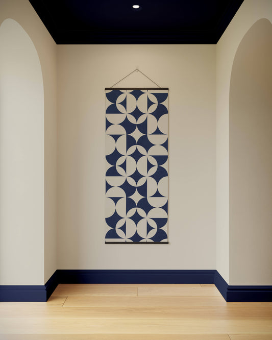Wall hanging with geometric pattern in a room with arches and a blue baseboard.