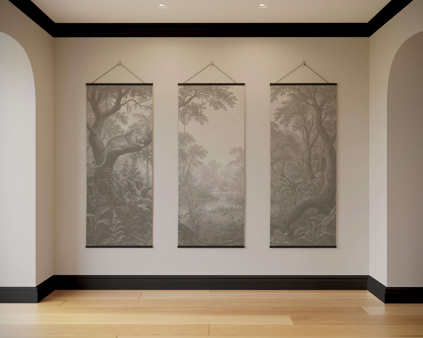 Three landscape wall hangings on a neutral wall with wooden flooring.