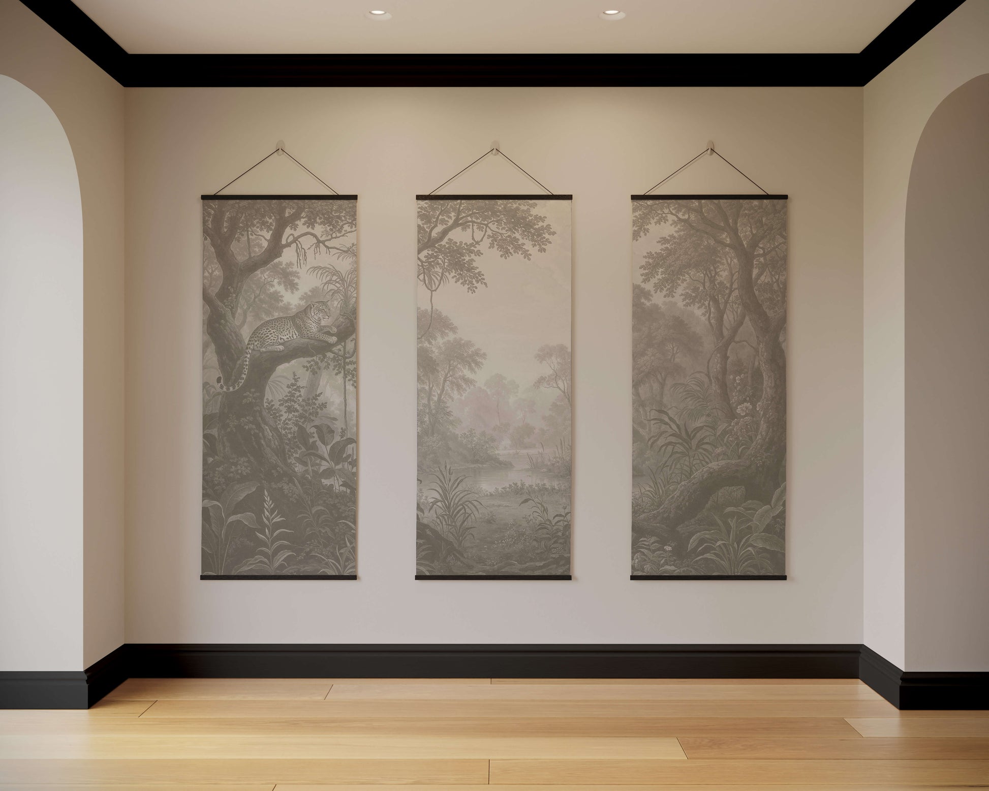 Three landscape wall hangings on a neutral wall with wooden flooring.