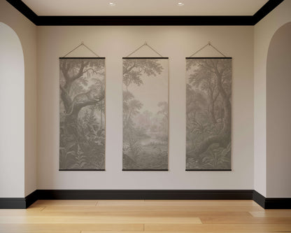 Three landscape wall hangings on a neutral wall with wooden flooring.