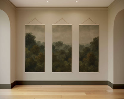 Three landscape paintings hanging on a wall in a room with wooden flooring.