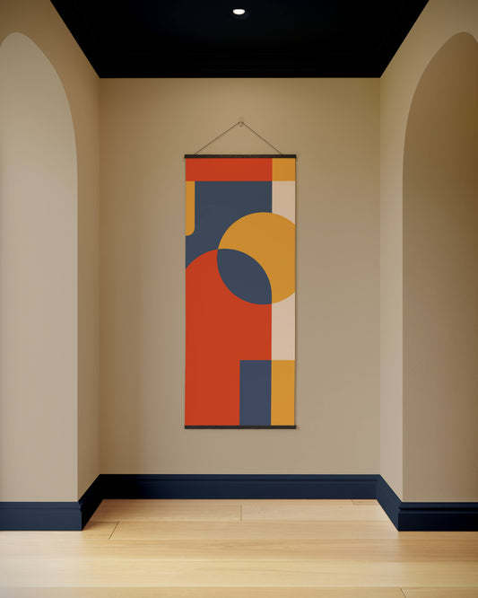 Colourful geometric wall hanging on a beige wall with arches and a dark ceiling.