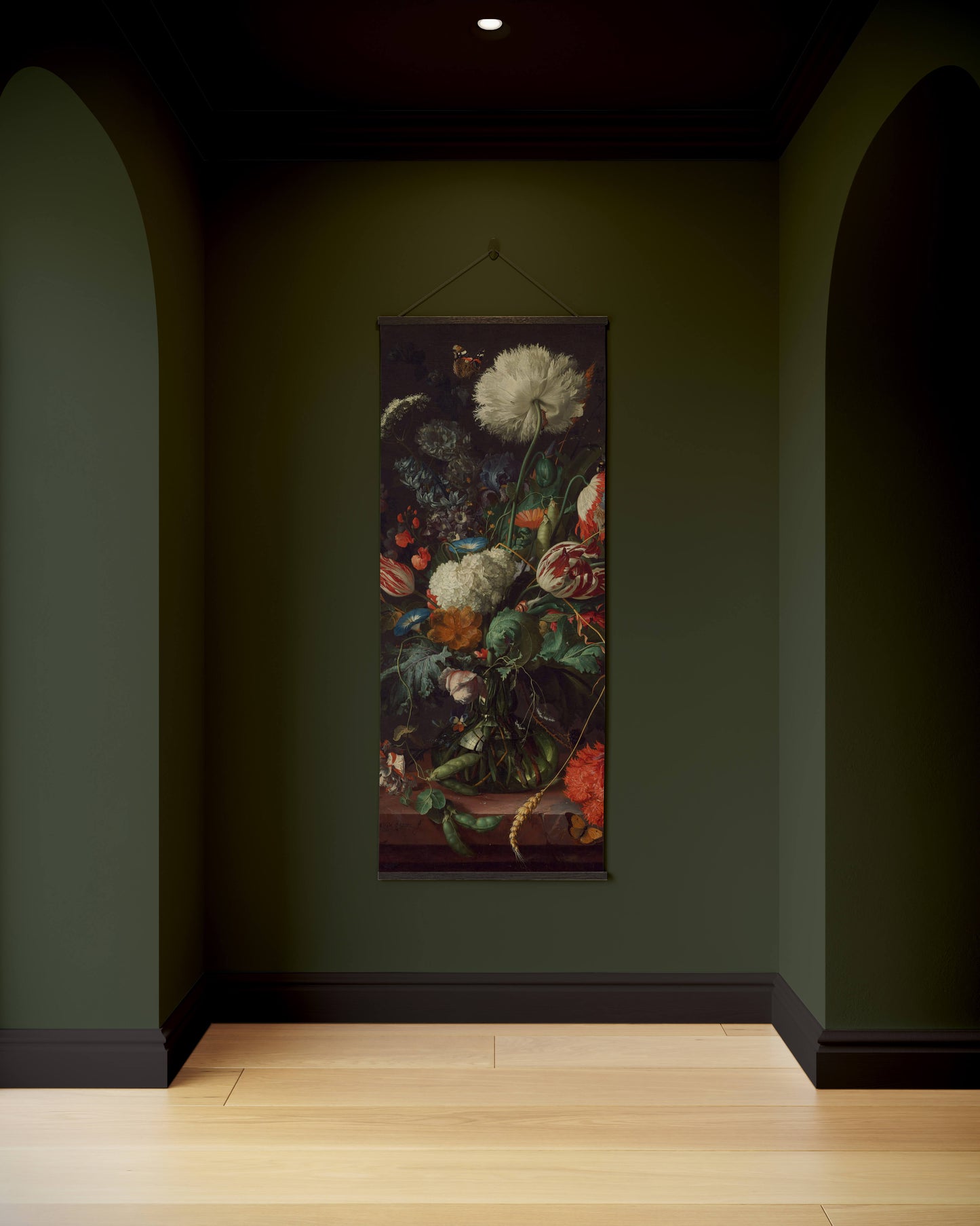 Floral tapestry hanging on a dark green wall in a dimly lit room.