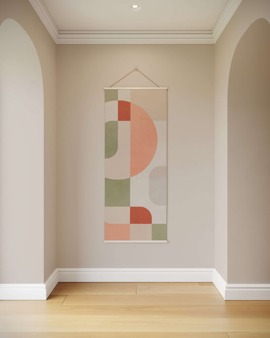 Abstract wall hanging with geometric design on a neutral wall.
