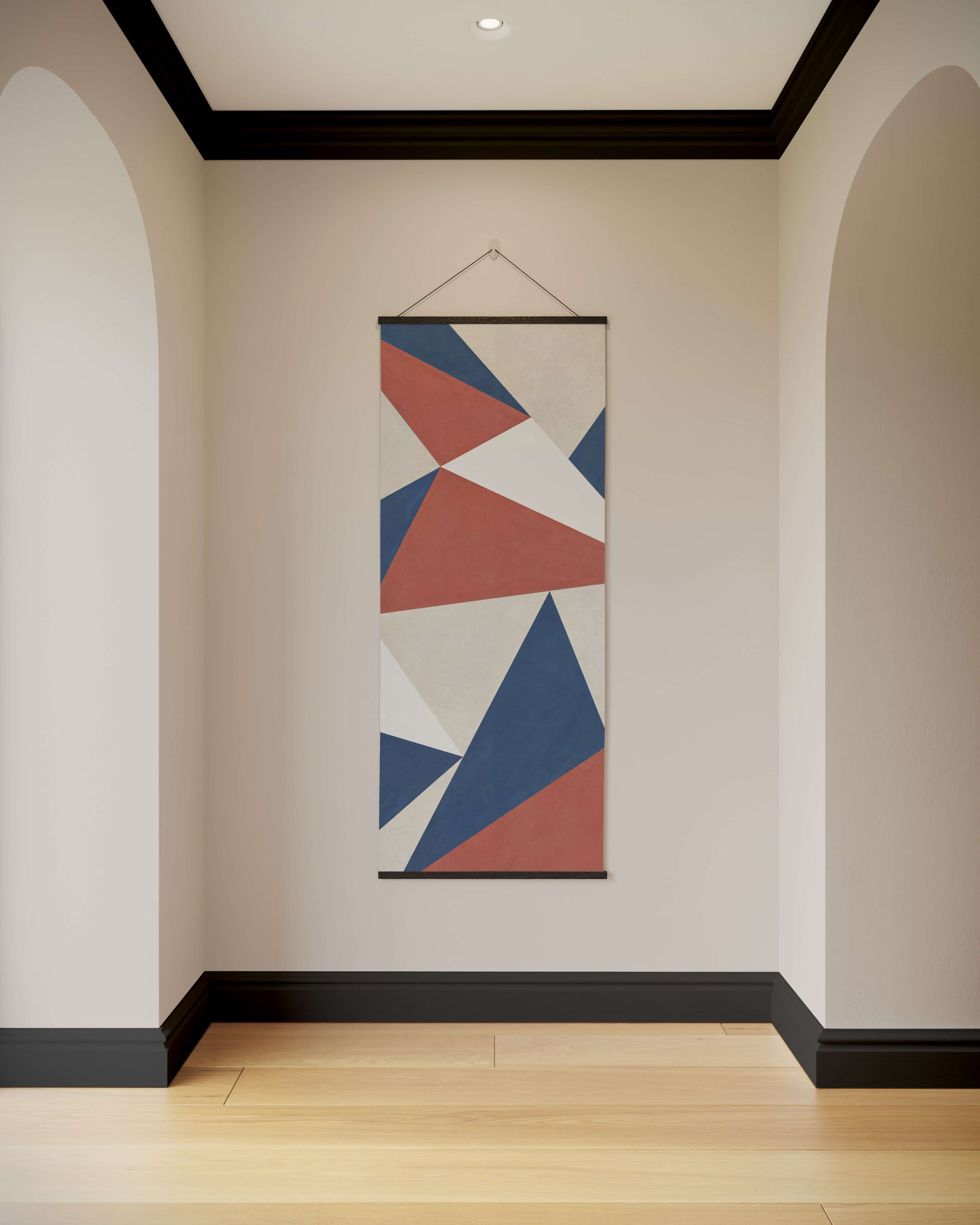 Geometric patterned tapestry hanging on a wall in a room with wooden flooring.