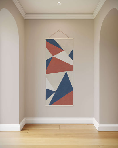 Geometric abstract art hanging on a wall in a room with wooden flooring.