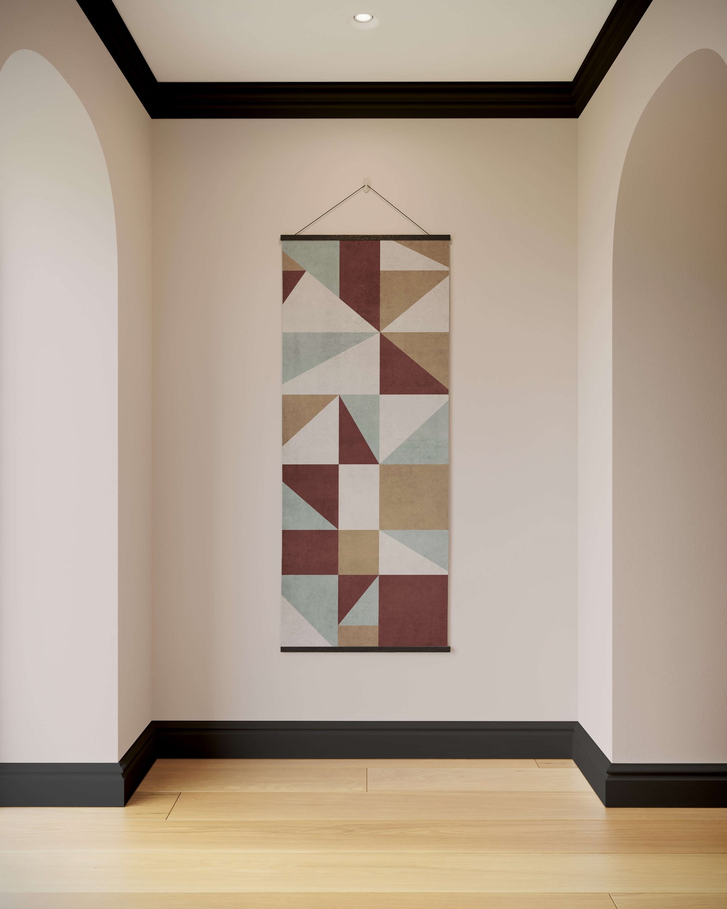 Geometric patterned tapestry hanging on a wall in a room with arches and wooden flooring.