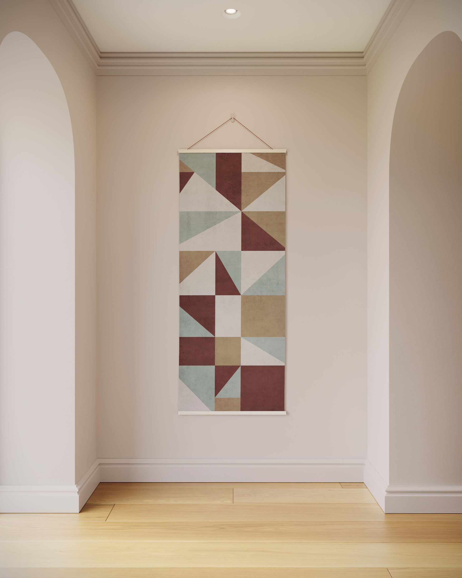 Geometric patterned wall hanging on a plain wall with arches and wooden floor.