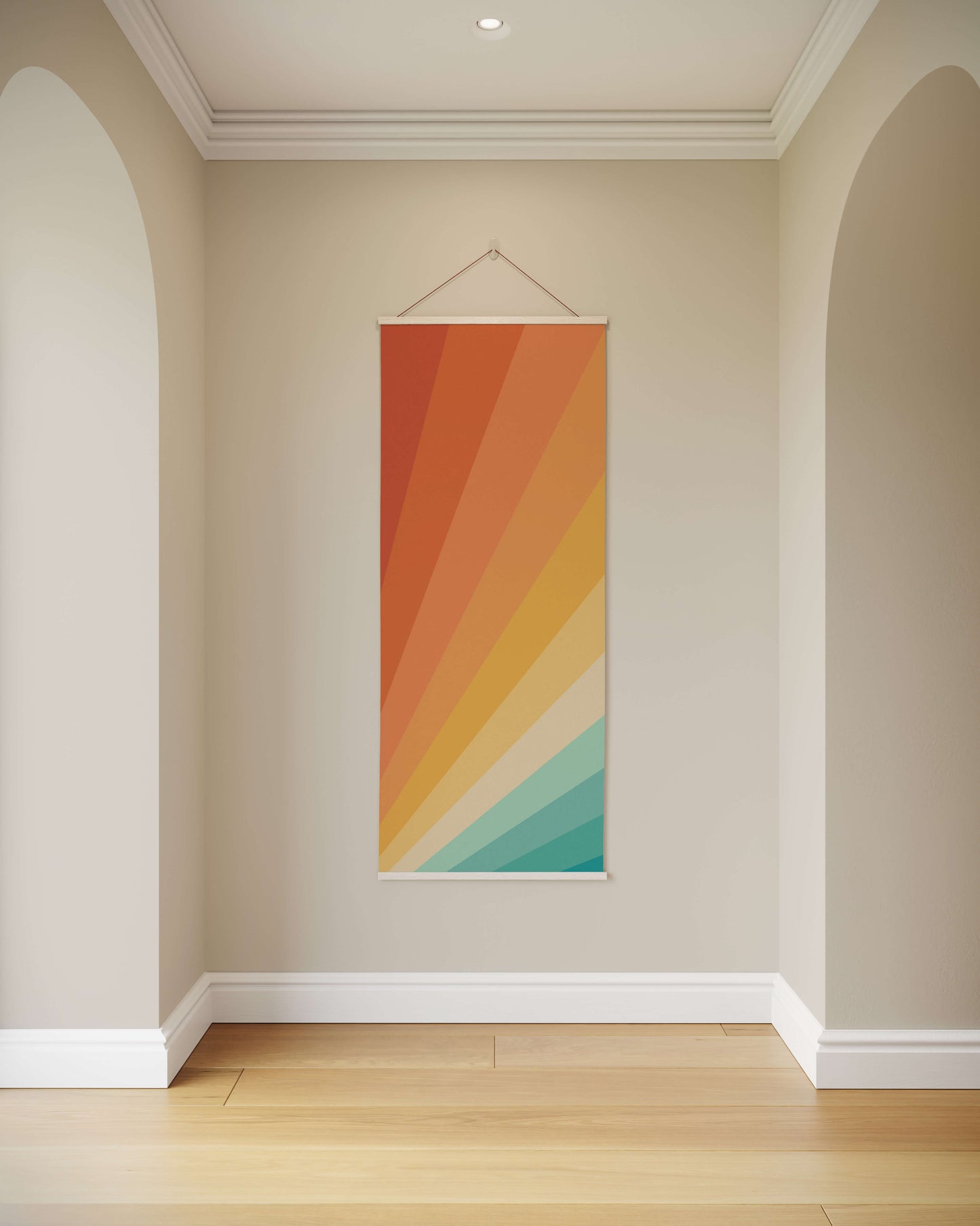 Colourful abstract wall hanging on a plain wall with a wooden floor
