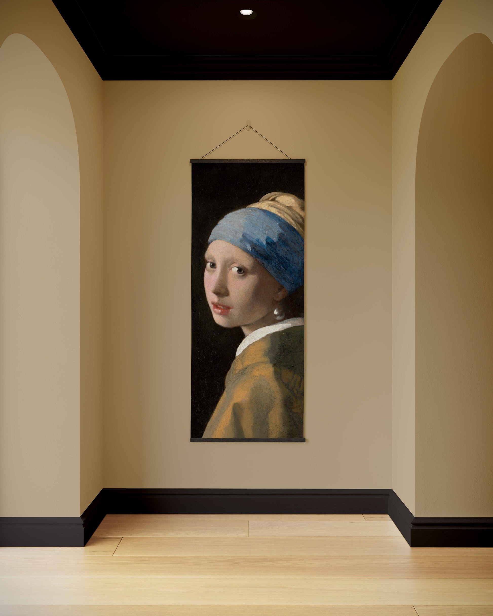 Artistic reproduction of 'Girl with a Pearl Earring' by Johannes Vermeer on a wall in a room.