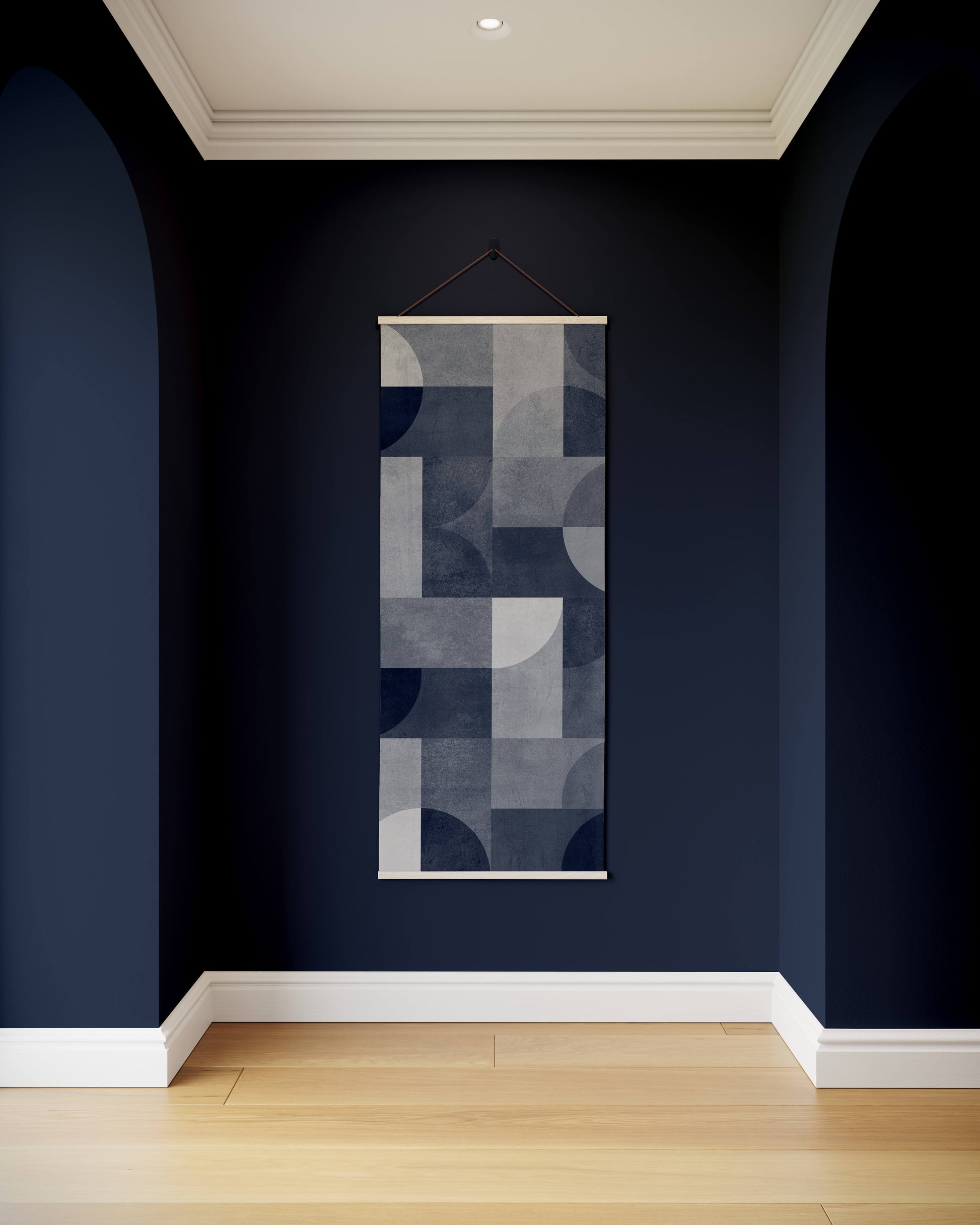 Abstract wall art hanging on a dark blue wall with wooden floor