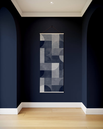 Abstract wall art hanging on a dark blue wall with wooden floor