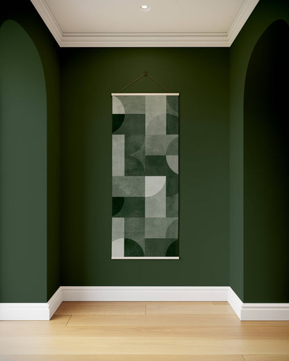 Abstract wall art hanging on a green wall with wooden flooring