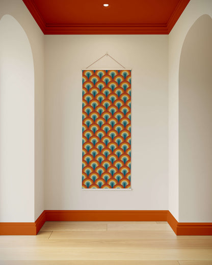 Colourful geometric patterned poster on a white wall with red trim.