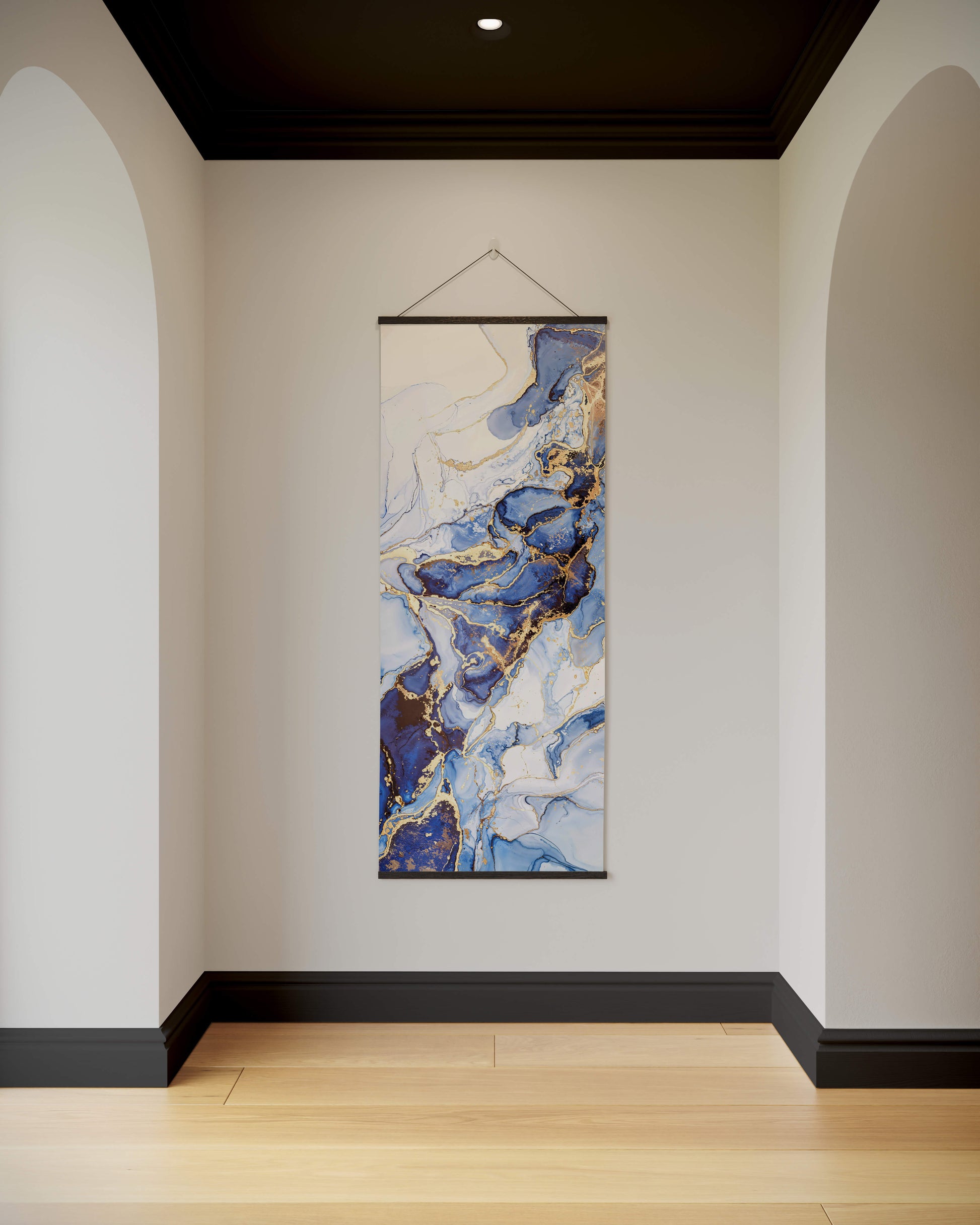Abstract art hanging on a wall in a room with white walls and wooden flooring.