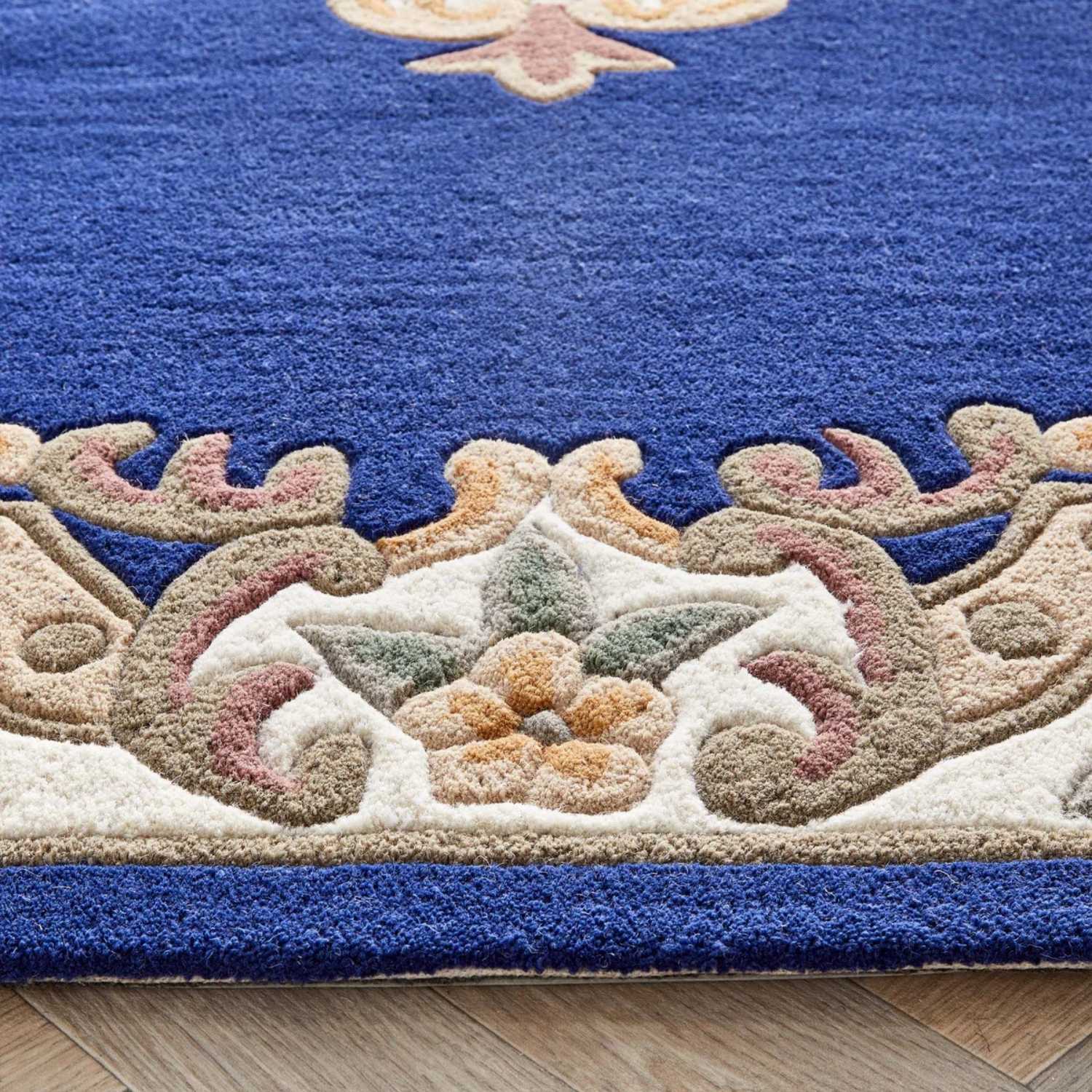 Decorative rug with intricate patterns on a wooden floor