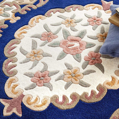 Close-up of a floral-patterned rug with a blue border