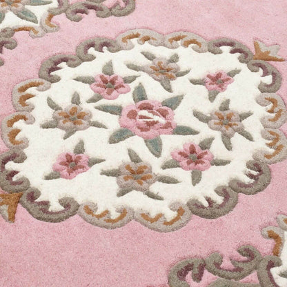 Close-up of a floral embroidered design on a pink background