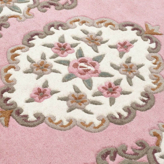 Close-up of a floral embroidered design on a pink background