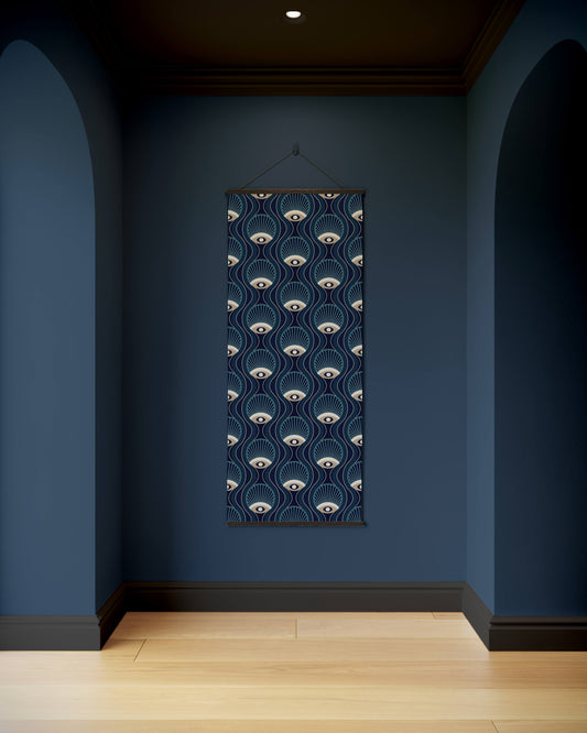 Decorative wall hanging with eye pattern on a blue wall
