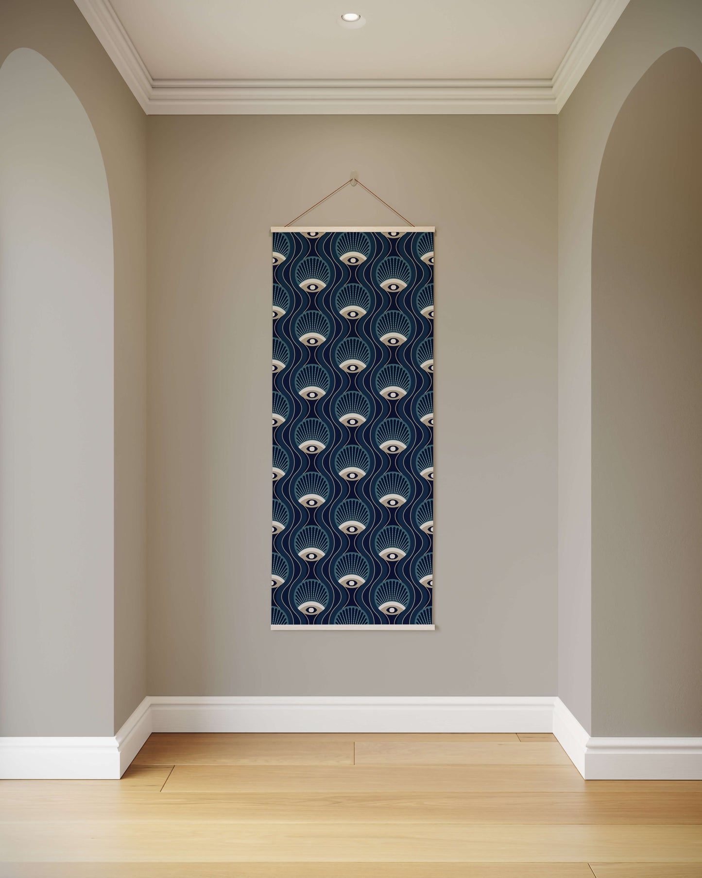 Wall art with a blue and white pattern hanging on a plain wall.