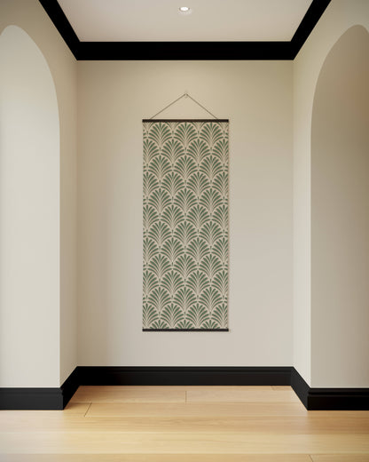 Decorative wall hanging with a green leaf pattern on a beige wall.