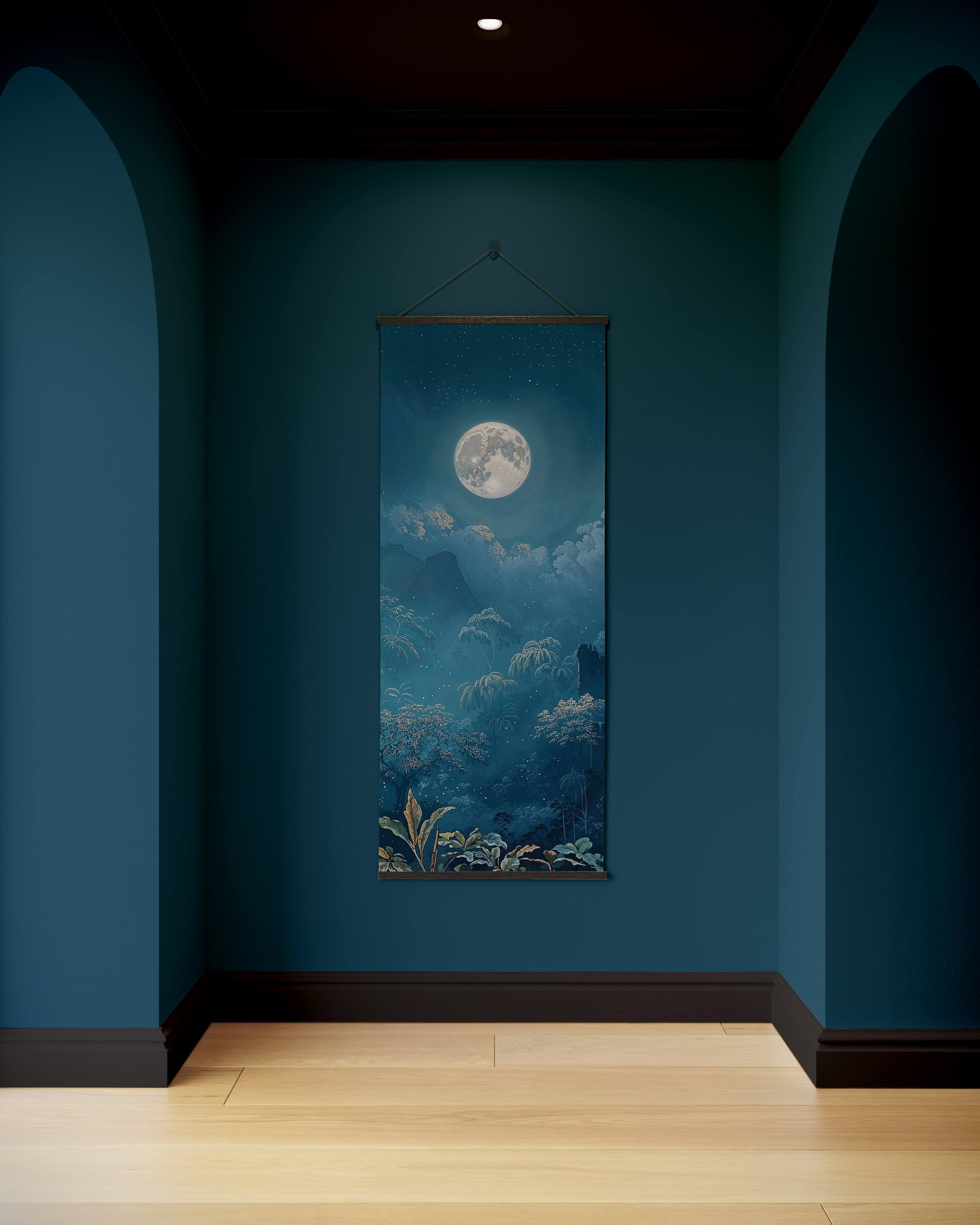 Wall tapestry with a moonlit landscape hanging on a blue wall.