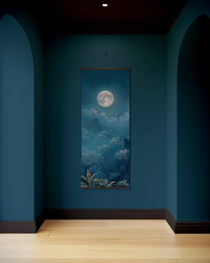Wall tapestry with a moonlit landscape hanging on a blue wall.