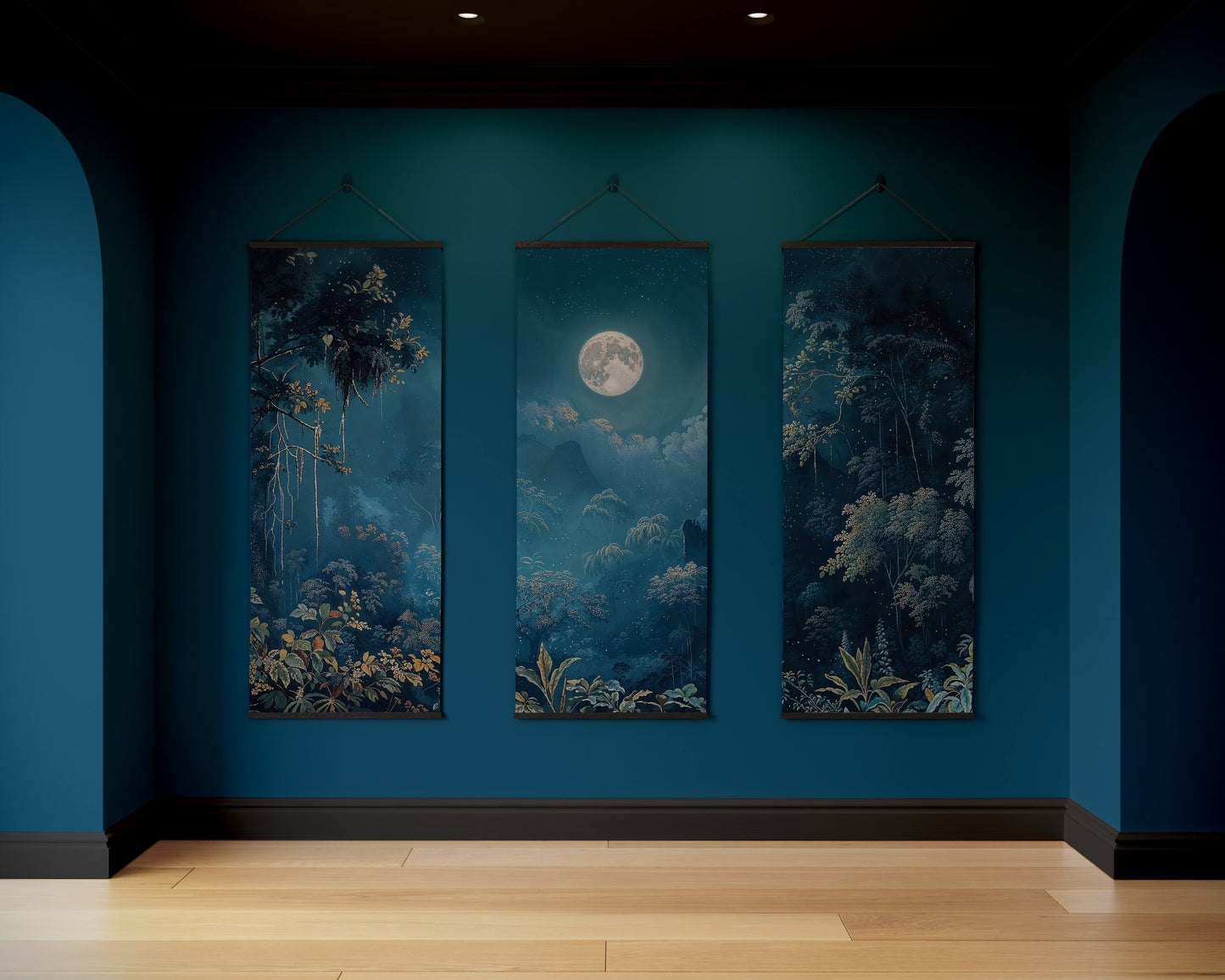 Three framed artworks on a blue wall with a wooden floor.
