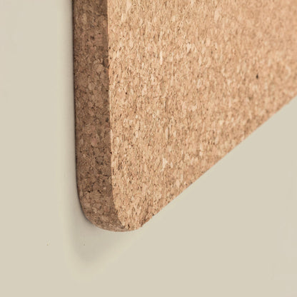 Close-up of a cork board corner on a neutral background