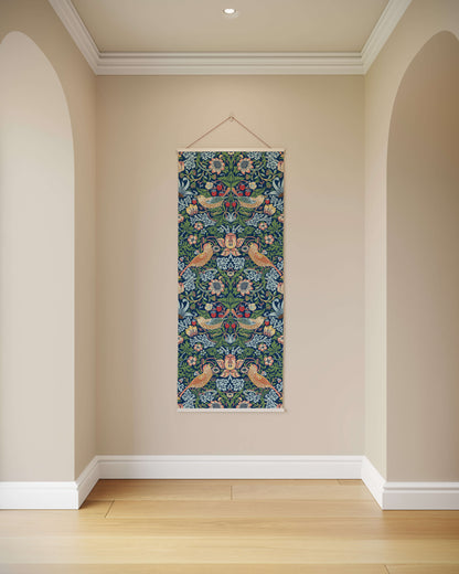 Decorative floral tapestry hanging on a beige wall with wooden floor.