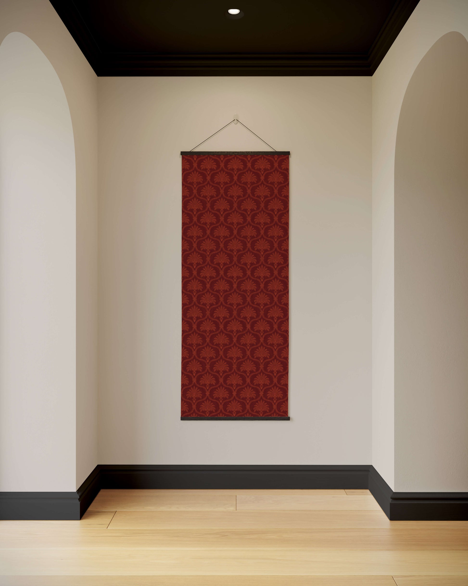 Red patterned wall hanging on a white wall with arches and a black ceiling.