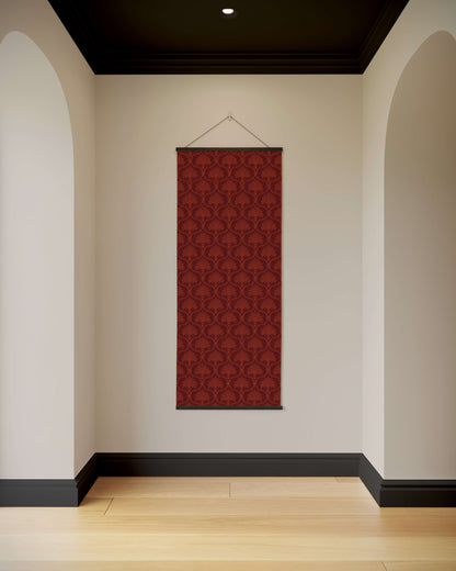 Red patterned wall hanging on a white wall with arches and a black ceiling.
