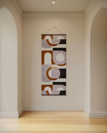 Abstract wall tapestry hanging on a plain wall in a room with wooden flooring.
