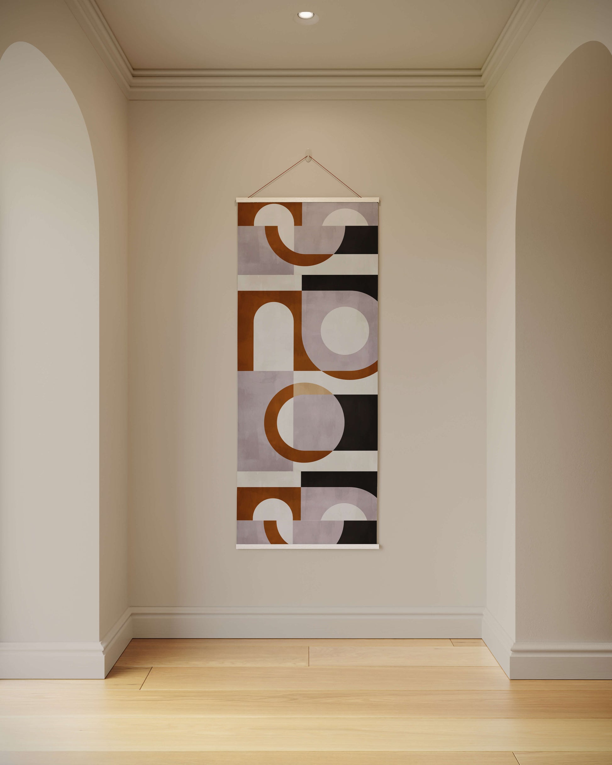 Abstract wall art hanging on a plain wall in a room with wooden flooring.