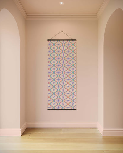 Decorative wall hanging with geometric pattern in a room with beige walls and wooden floor.