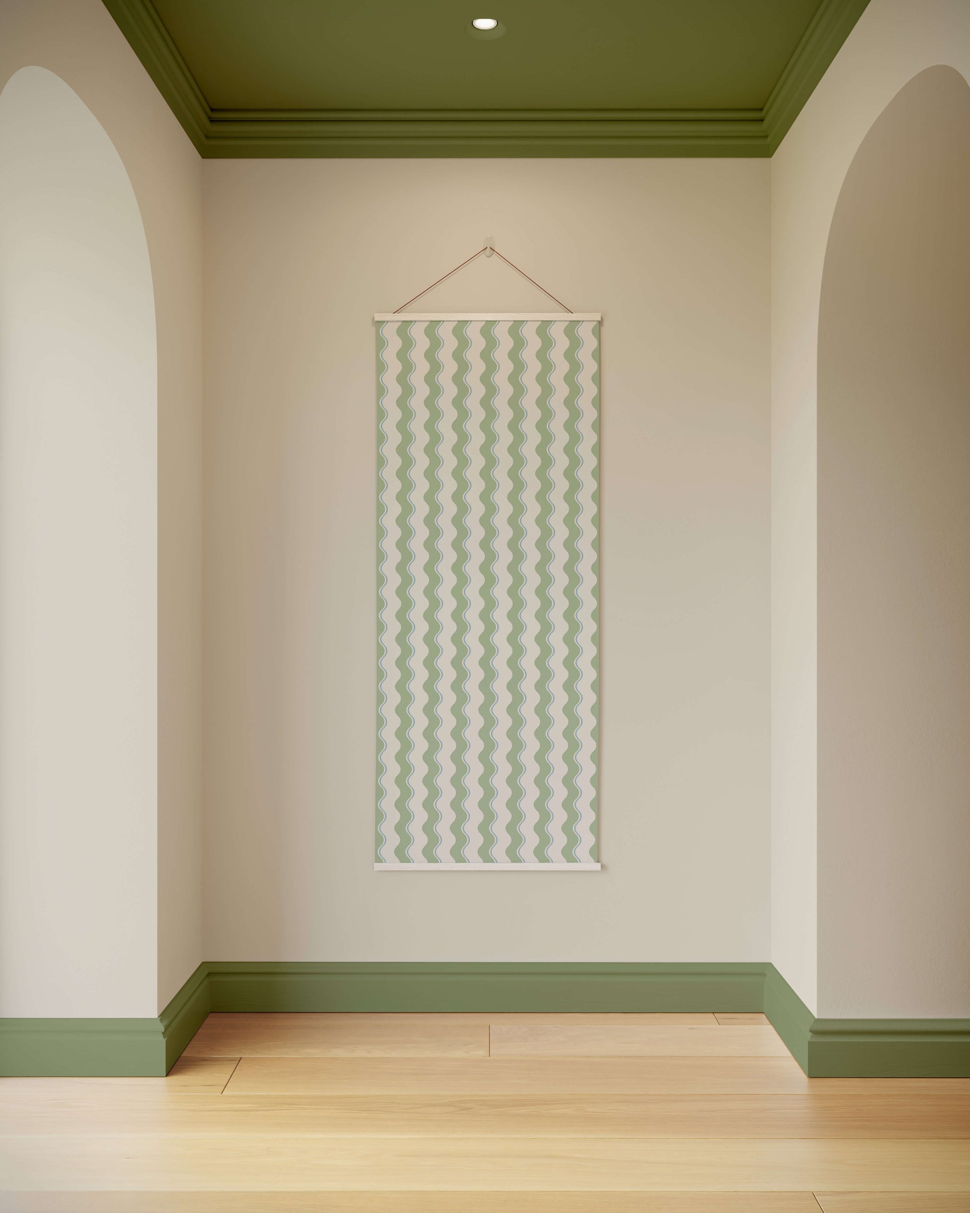 Wall with a decorative hanging panel in a room with green ceiling and baseboards.