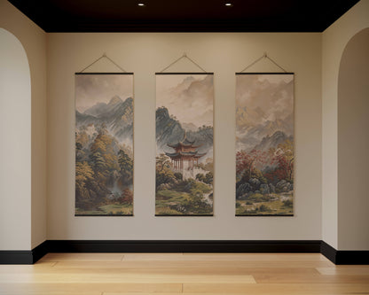 Three hanging landscape paintings on a wall with a neutral colour scheme.