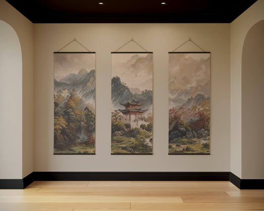 Three hanging landscape paintings on a wall with a neutral colour scheme.