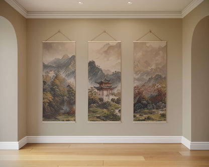 Three hanging tapestries depicting mountain landscapes on a beige wall.